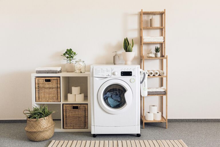 A washer and dryer in a room - How to Fix a Leaking Washing Machine