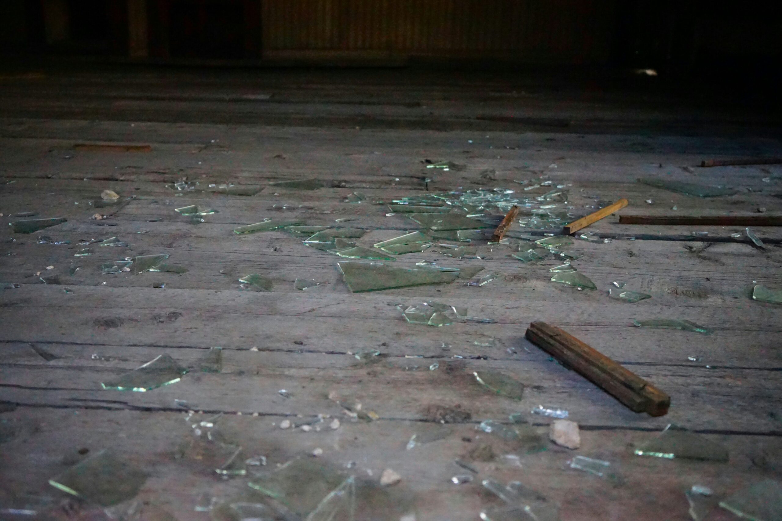 Glass from a broken window laying across the ground - How to Replace a Broken Floor Tile in Your Bathroom