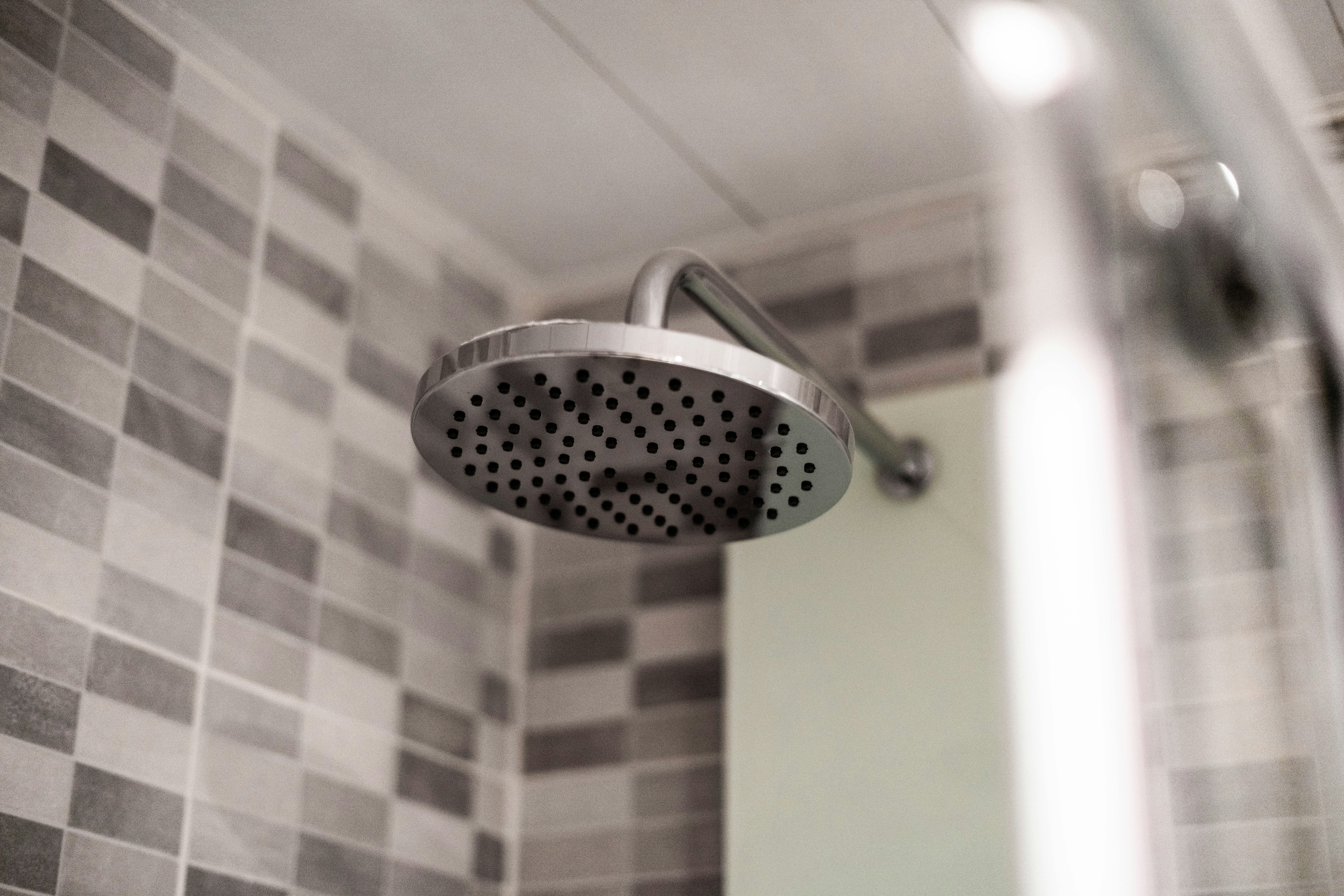 Grey stainless steel shower head - How to Reseal a Shower Tray to Prevent Leaks