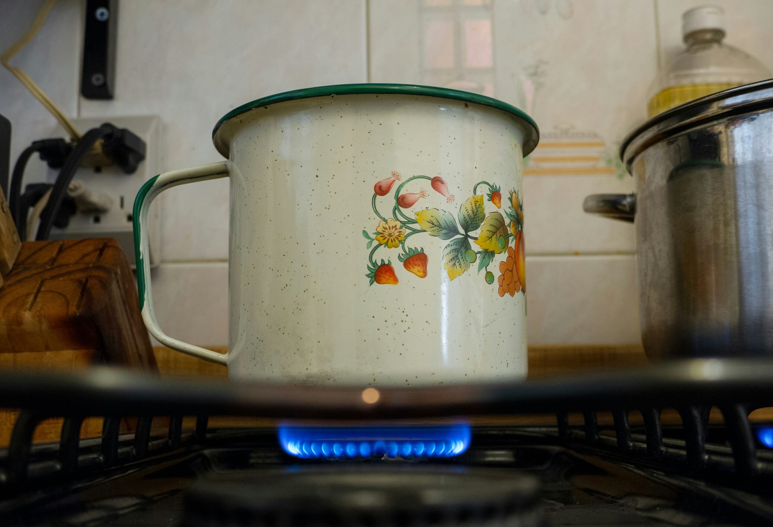 White and pink floral cooking pot on stove - How to Troubleshoot a Boiler Not Heating Water
