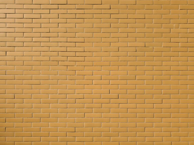 a yellow brick wall with a red stop sign