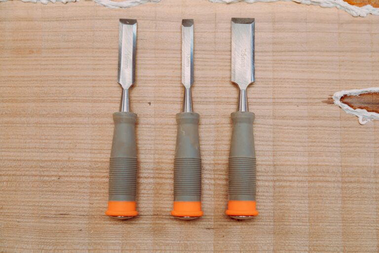 Set of chisels on wooden table. Tools for wood work - Best Chisels for Woodworking at Home