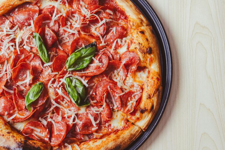 a close up of a pizza on a plate on a table