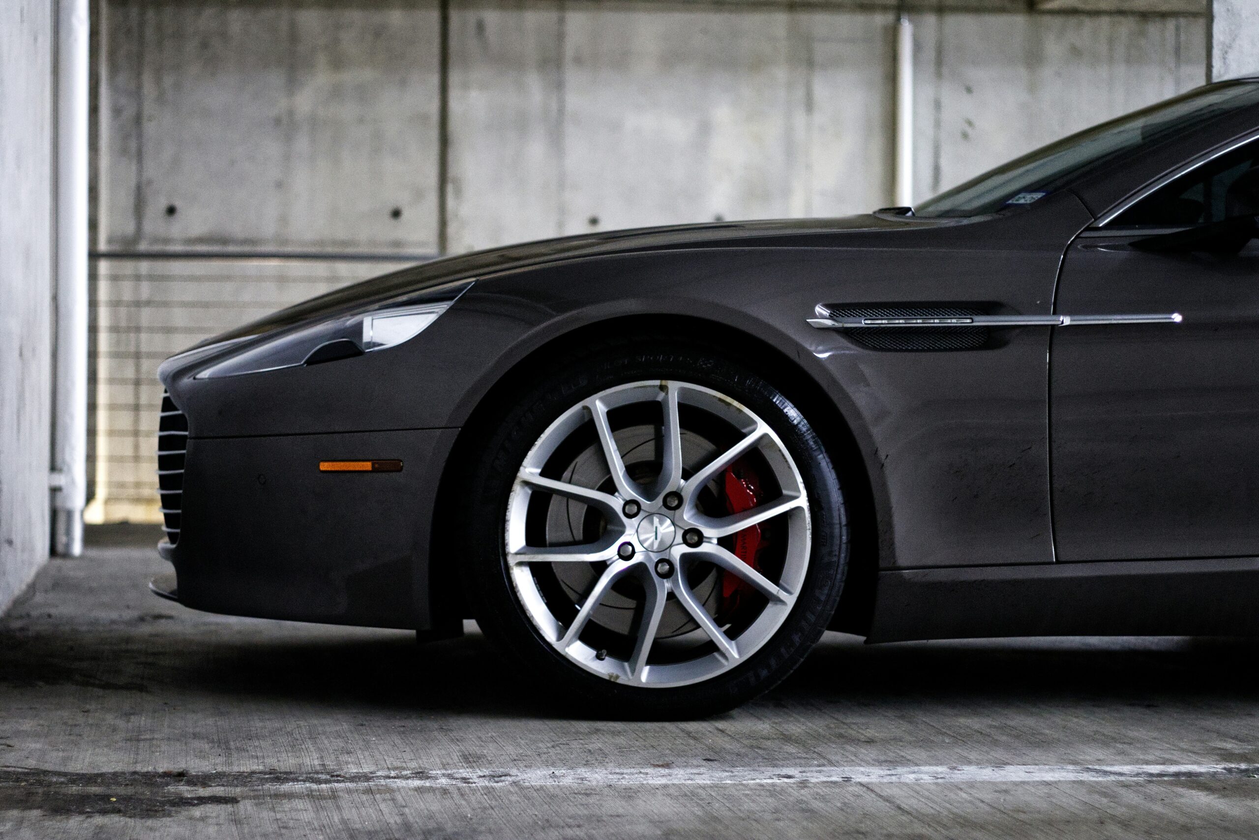 Dark grey luxury car parked indoors