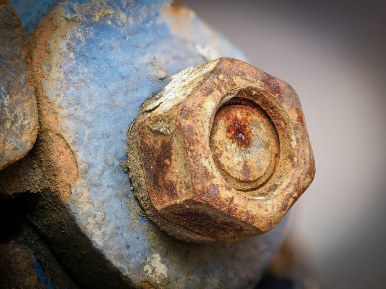 A rusted metal object with a hole in the middle
