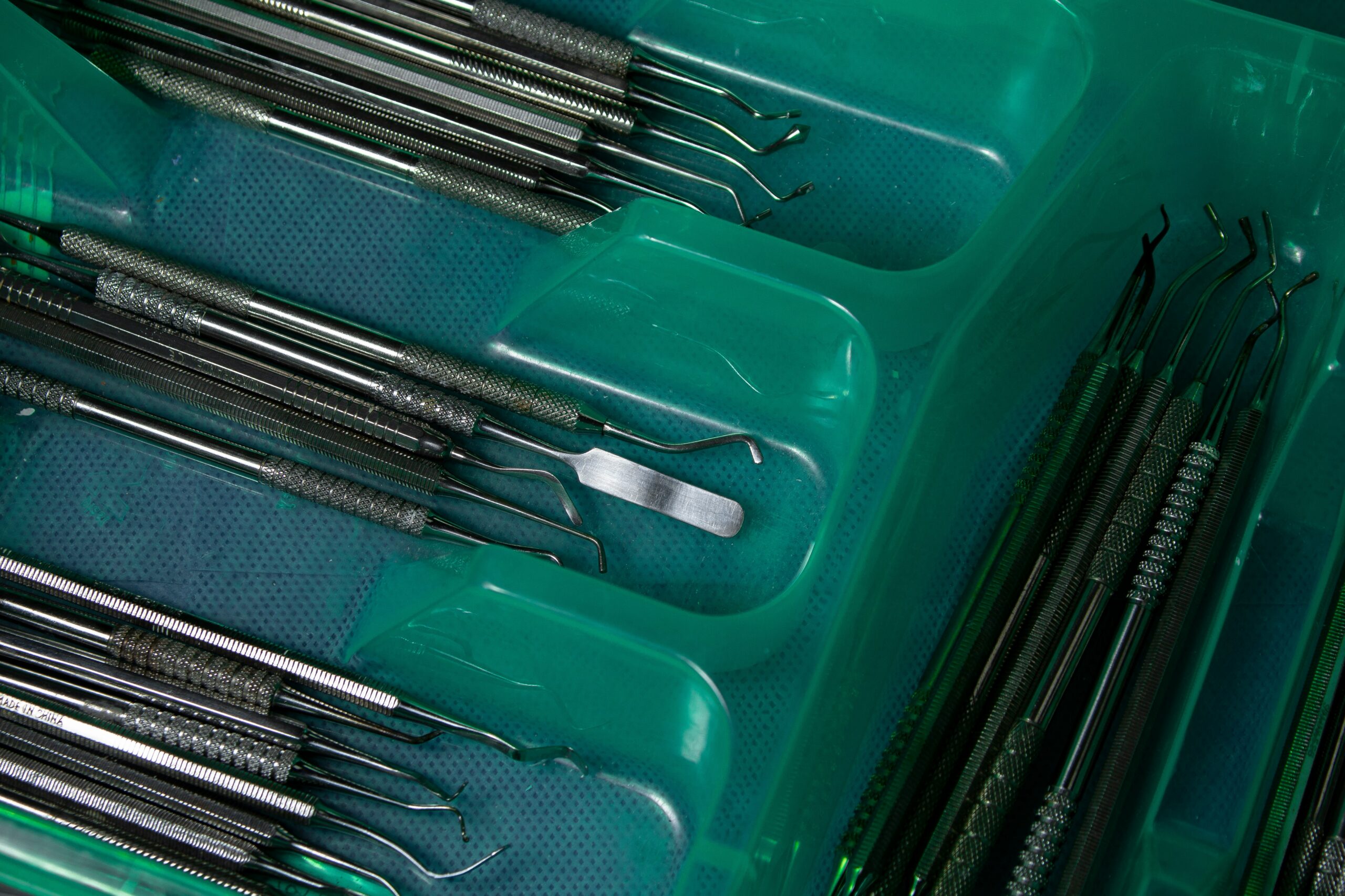 a green box filled with lots of surgical tools