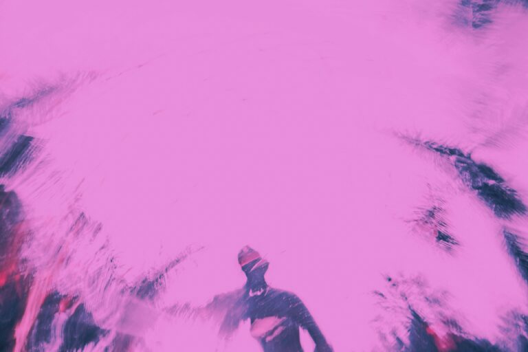 a blurry image of a man riding a snowboard