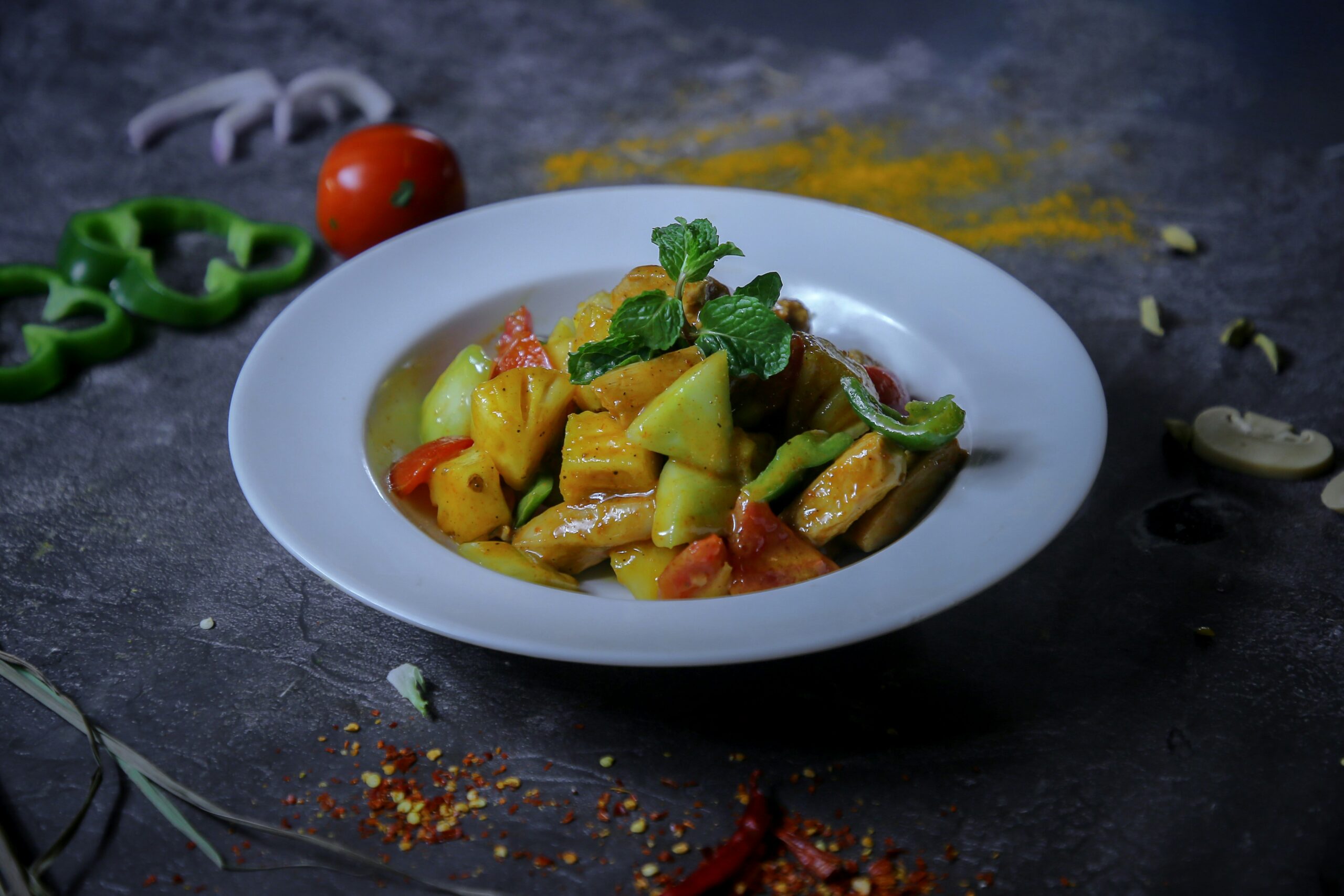 A delicious dish of paneer tikka with fresh mint leaves.