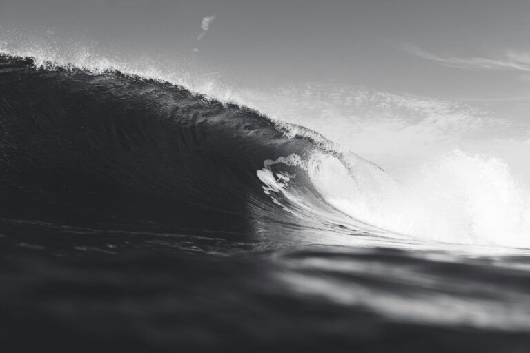 a person riding a wave on top of a surfboard
