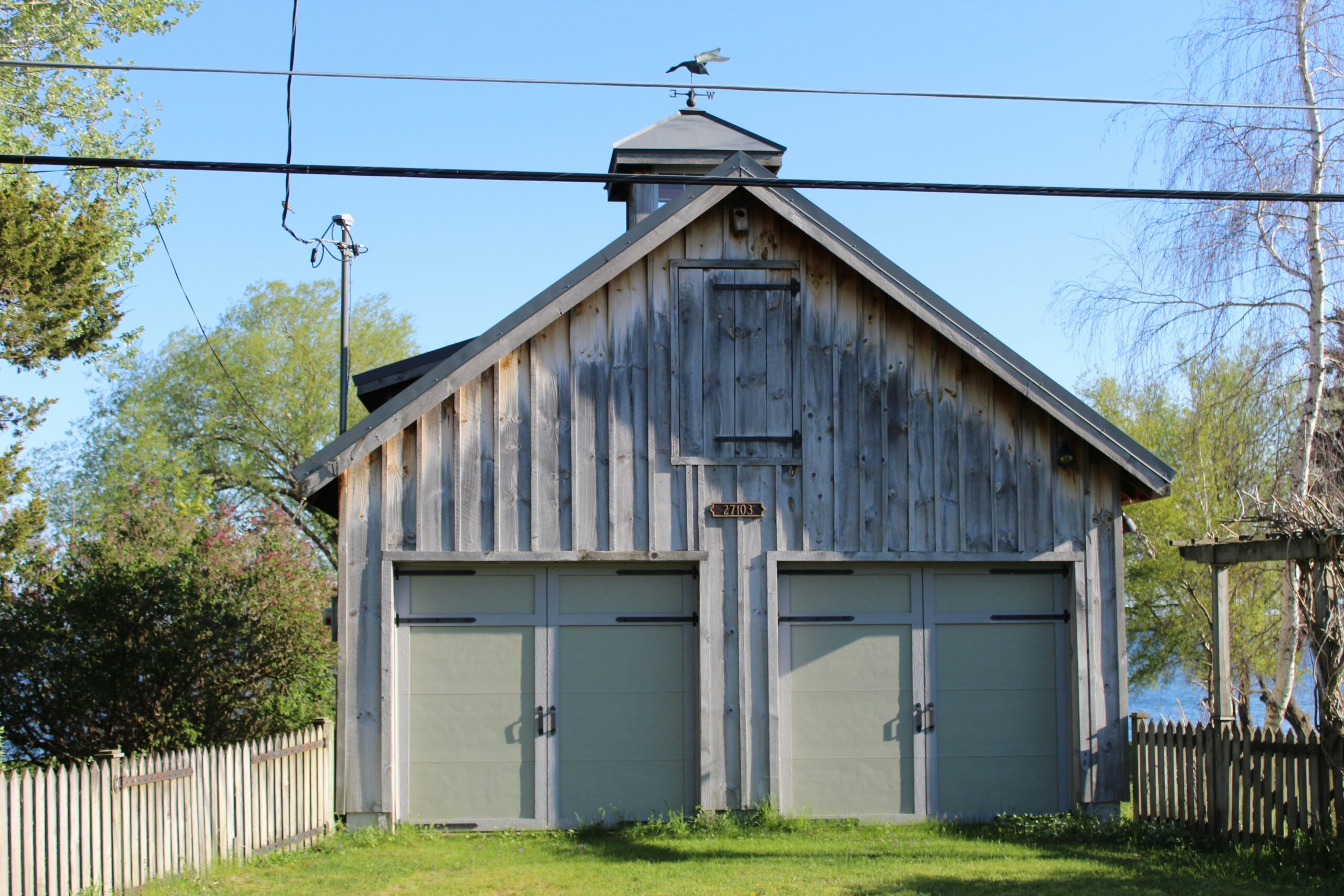 a wooden building with two doors and a steeple
