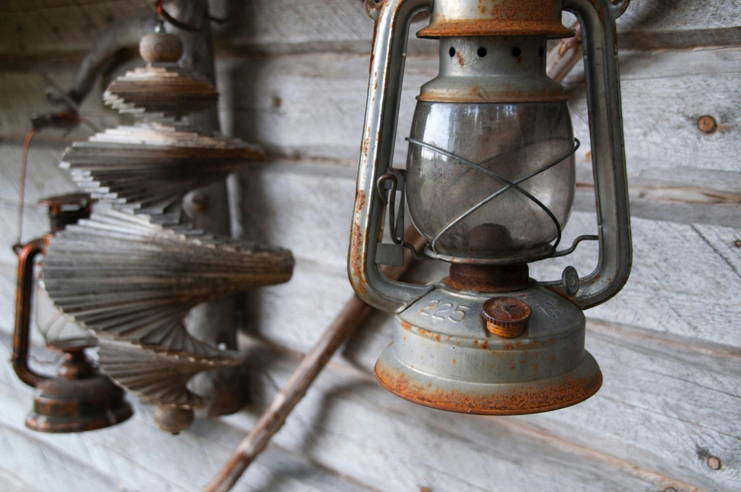an old light hanging from the side of a building
