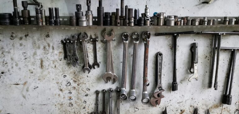 a bunch of wrenches hanging on a wall