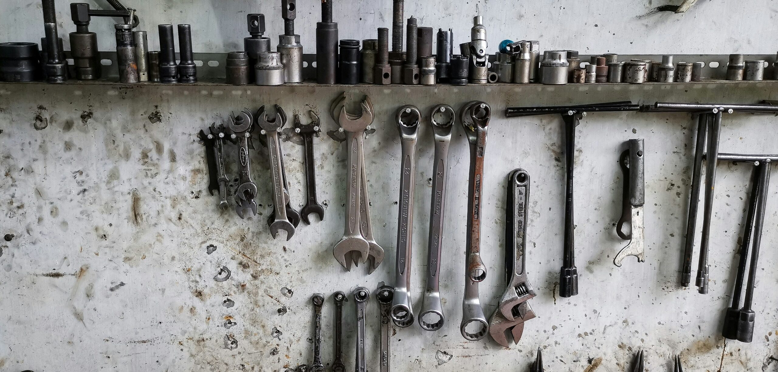 a bunch of wrenches hanging on a wall