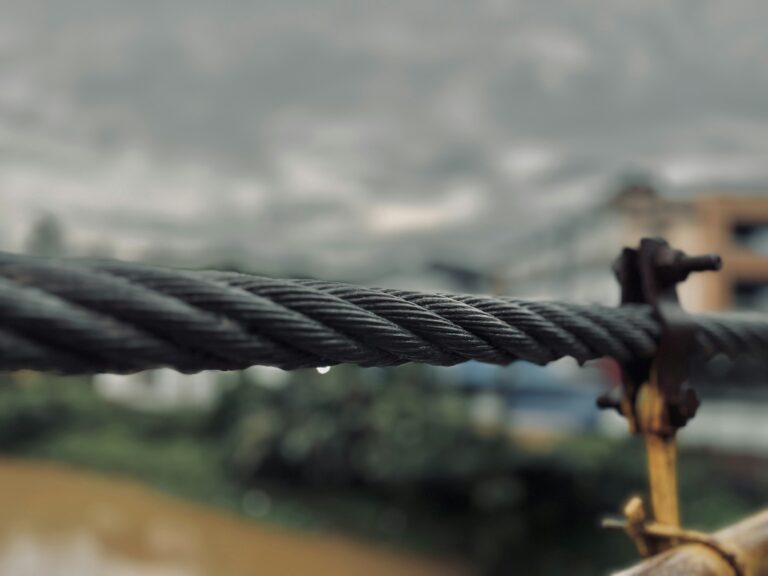 a close up of a rope with a building in the background